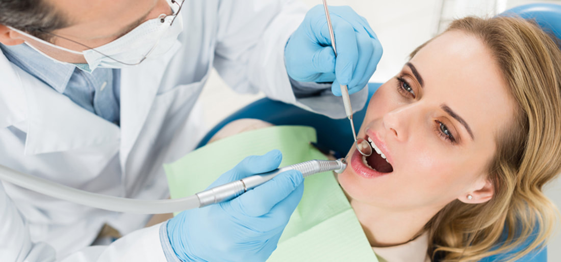 Dentist treating patient as for dental problem preventation.