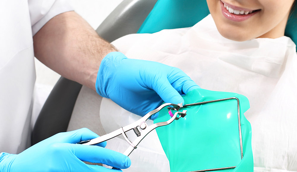 Male dentist giving root canal therapy to female patient.